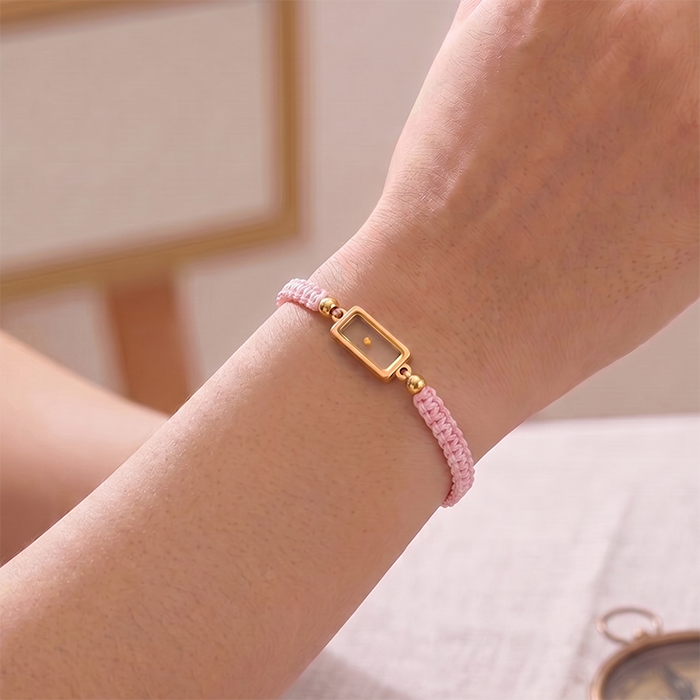 Seed of Faith Bracelet in pink cord worn on a wrist