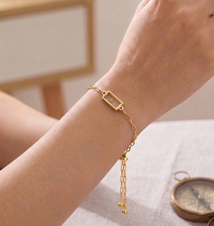 Seed of Faith Bracelet, gold tone paperclip chain worn on a wrist