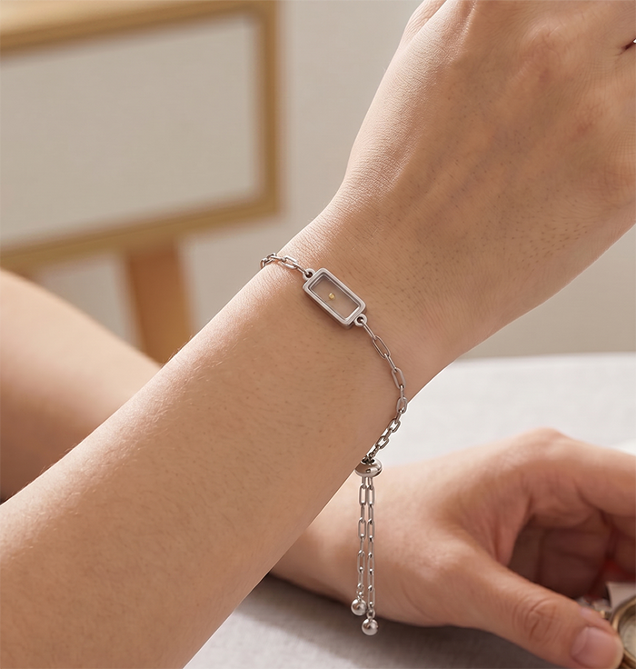 Seed of Faith Bracelet, silver tone paperclip chain worn on a wrist